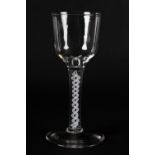 A MID 18TH CENTURY WINE GLASS with ogee bowl on an opaque twist stem and conical foot, 16cm high