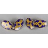 A PAIR OF ENAMEL ON SILVER GILT CUFFLINKS, each oval face set with a cloisonné gilt knot or splice