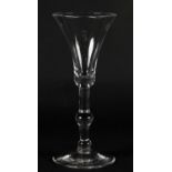 A MID 18TH CENTURY WINE GLASS, the bell bowl on a baluster stem and conical foot, 19.75cm