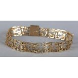 A BRACELET c.1978 in 9ct gold pierced and textured Modernist links of square outline, approximate