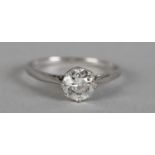 A SINGLE STONE DIAMOND RING IN PLATINUM c.1950, the brilliant cut stone claw set flanked by tubed