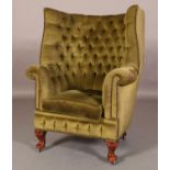 AN 18TH CENTURY STYLE PORTER'S CHAIR, close nail button upholstered and on short cabriole legs and