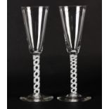 A PAIR OF MID 18TH CENTURY WINE GLASSES with funnel bowl, on an opaque double twist stem on a