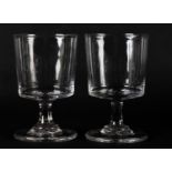 A PAIR OF 18TH CENTURY WINE GLASSES with deep bucket bowl on a short stem, cushion knop and heavy