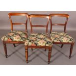 A SET OF THREE VICTORIAN ROSEWOOD DINING CHAIRS, the open backs with plain tie rails, needlework