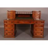 A VICTORIAN MAHOGANY DESK having a raised back with spindle gallery above an open compartment and