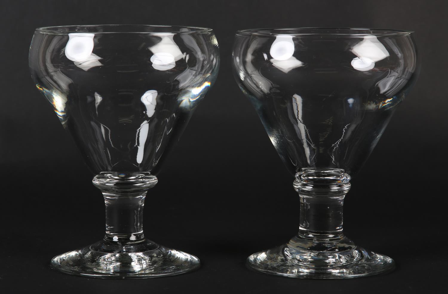 TWO LARGE 19TH CENTURY GOBLETS with ogee bowls, the short stem with knop to shoulder, on conical