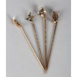 FOUR EARLY 20TH CENTURY STICK PINS, all in 9ct gold, variously set with aquamarines, seed pearls and