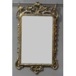 A GEORGE III GILTWOOD WALL MIRROR of rectangular outline, the frame having a pierced and carved