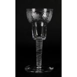 A WINE GLASS, the double ogee bowl cut and engraved with grape and vine on a airtwist stem and plain