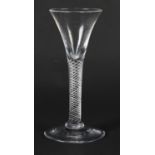 A MID 18TH CENTURY WINE GLASS with drawn trumpet bowl on an air twist stem and conical foot, 16.