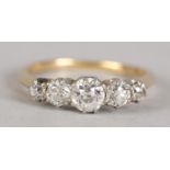 AN EDWARD VII FIVE STONE DIAMOND RING IN 18CT GOLD AND PLATINUM, the graduated Old European cut