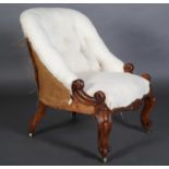A VICTORIAN WALNUT NURSING CHAIR, button upholstered back in the white, leaf carved and scroll arms,