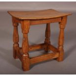 THOMPSON OF KILBURN 'MOUSEMAN', an oak stool, with dished rectangular seat on octagonal turned and