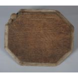 THOMPSON OF KILBURN 'MOUSEMAN', an oak cheeseboard of irregular octagonal outline, carved in