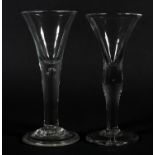 A MID 18TH CENTURY WINE GLASS with trumpet bowl, on a plain stem with tear, folded conical foot,