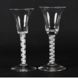 A MID 18TH CENTURY WINE GLASS with a bell bowl, on a double opaque twist stem and conical foot, 16cm