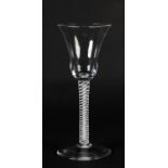 A MID 18TH CENTURY WINE GLASS, the bell bowl on a double series stem with opaque spiral around a