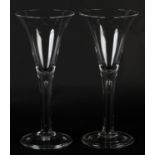 A PAIR OF LARGE 19TH CENTURY WINE GLASSES with drawn trumpet bowls, tear drop stem on folded domed