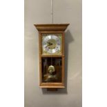 An oak and glazed wall clock with gilt dial, silver chapter ring with Roman numerals by David