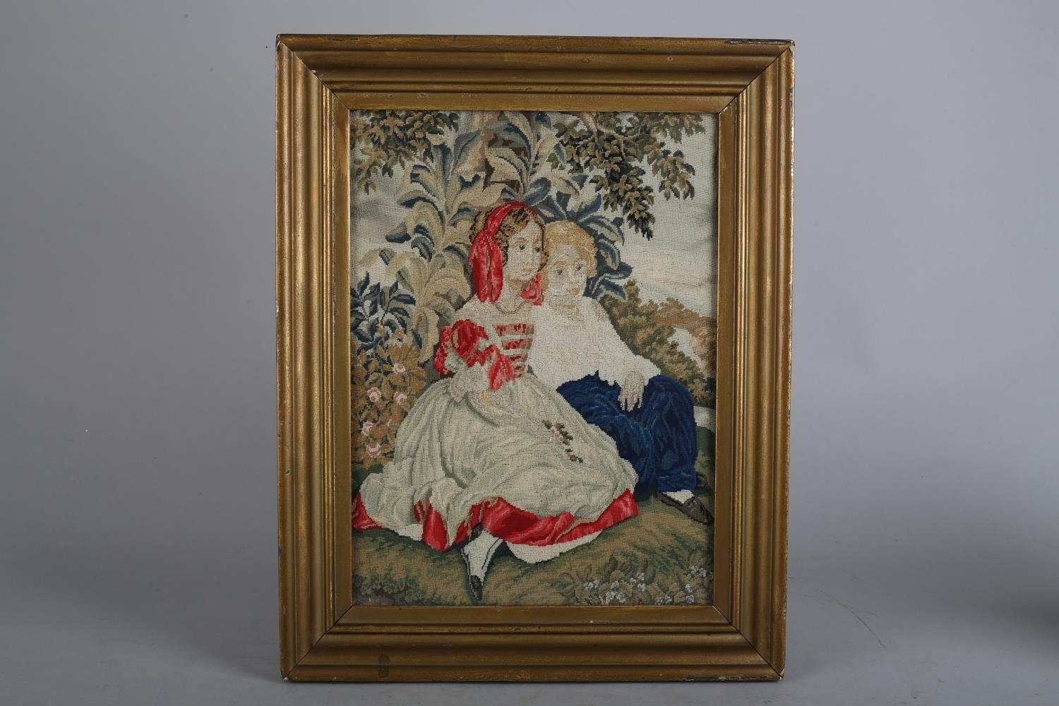 A 19TH CENTURY PETIT GROS NEEDLEWORK PANEL worked in coloured silks with a boy and girl sitting in a