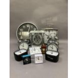 A quantity of clocks including wall, mantle and alarm clocks