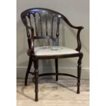 An Edwardian mahogany open tub back chair with arcaded and railed back, floral needlework seat and