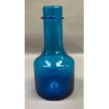 An Iittala blue glass bottle shaped vase etched to the underside with indistinct monogram and 100