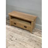 A contemporary oak veneered television table, rectangular, open shelf and two drawers below on stile