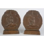 A PAIR OF BRONZE SAINT GEORGE BOOKENDS, c.1920s of circular outline each with sleeping dragon