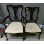 An Edwardian mahogany carver and single chair with foliate cresting, pierced splat, upholstered seat