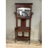 An Edward VII mahogany and satinwood banded hall stand having a moulded cornice above three hat pegs