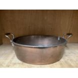 A copper two handled pan
