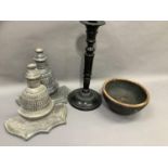 A heavy black metal candle stick, a pair of grey stained wood wall brackets and a wooden bowl
