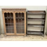 An oak and leaded glazed two door bookcase together with a set of open bookshelves of four