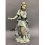 A Lladro figure of a girl in elaborate costume wearing flowing robe, tunic and pantaloons with