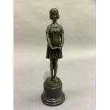 A reproduction bronze figure after D.N Chiparus of a young woman, standing with hands clasped,