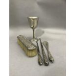 A silver backed clothes brush, a silver handled shoe horn and two silver handled button hooks