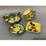 A Mickey Mouse printed tin tea service comprising teapot, three cups, eight saucers (5 & 3) and