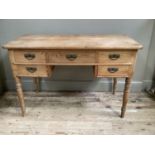 A pine desk having three drawers across and a further drawer to either side of the kneehole on