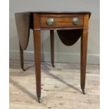 An Edwardian mahogany Pembroke table having oval drop leaves, drawer and dummy drawer to the