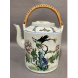 A large modern Chinese tea kettle, cylindrical form painted in coloured enamels with a bird