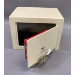 A small safe for wall mounting complete with keys