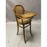 A late 19th century child's bentwood high chair with hinged tray by J.Kohn with bergere caned seat