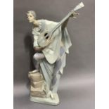A Lladro figure of a harlequin playing a lute, 47cm high