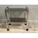 A white metal and glass two tier trolley