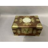 A Chinese hard wood and cut brass mounted jewel casket inset with a jade type carved and pierced