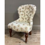 A floral upholstered button back boudoir chair on turned front legs
