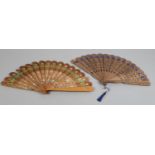 Two wood brisé fans, c 1880's, the first with shaped sticks and rounded tips, the wide sticks carved