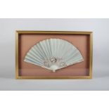 A slender 18th century ivory fan with sea green silk leaf, the monture finely painted with a central